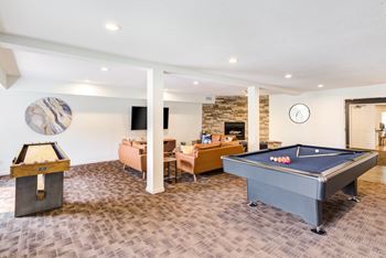 a recreation room with a pool table and a foosball table
